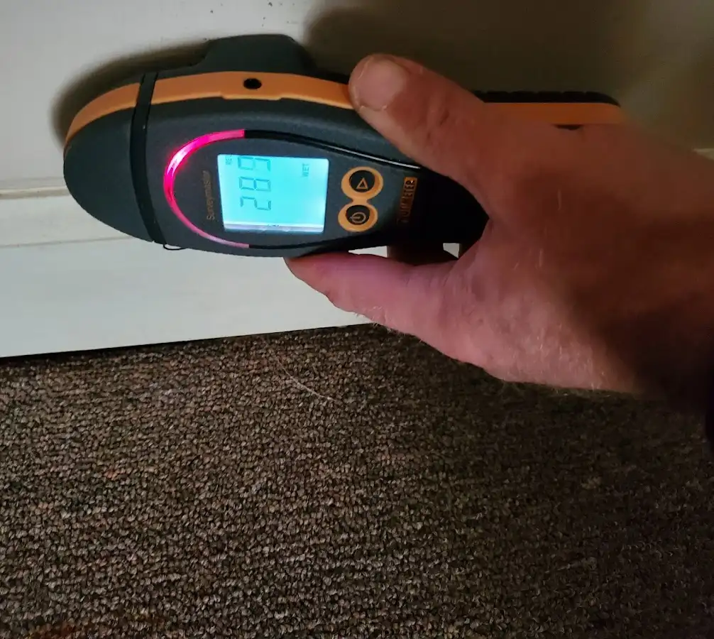 Moisture detection at baseboard during Storm Damage Restoration in Elsa